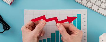 top-view-of-business-items-with-growth-chart-and-hands-holding-arrow